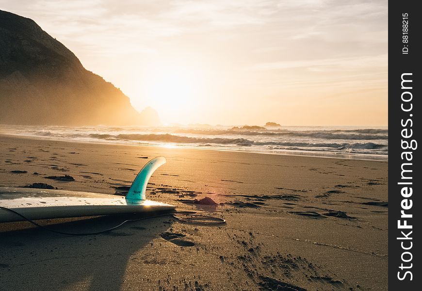 Surfboard Laying In Sand On Beach