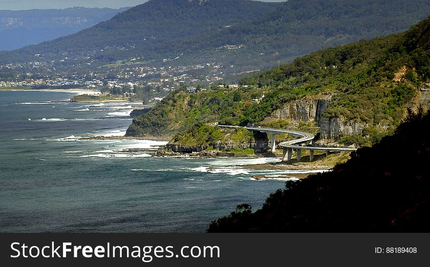 The Sea Cliff Bridge is a balanced cantilever bridge located in the northern Illawarra region of New South Wales, Australia. The $52 million bridge links the coastal villages of Coalcliff and Clifton. Featuring two lanes of traffic, a cycleway and a walkway, the Sea Cliff Bridge boasts spectacular views and is a feature of the scenic Lawrence Hargrave Drive. The Sea Cliff Bridge replaced a section of Lawrence Hargrave Drive that was permanently closed in August 2003 due to regular rock falls. A public outcry emerged over the road closure as Lawrence Hargrave Drive is the only road directly linking Coalcliff, Stanwell Park, Otford and Helensburgh to the northern suburbs of Wollongong. The bridge was officially opened by NSW Premier Morris Iemma at a &#x27;ribbon cutting&#x27; ceremony on 11 December 2005, and has met with great public approval and increased business for the area&#x27;s tourism industry. The Sea Cliff Bridge was named by 11-year-old schoolgirl Makenzie Russell &#x28;St. Brigids&#x29; following a naming competition opened to local primary school students. It is a popular location for Love padlocks. The Sea Cliff Bridge is one of only seven off-shore parallel to coast bridges in the world. The Sea Cliff Bridge is a balanced cantilever bridge located in the northern Illawarra region of New South Wales, Australia. The $52 million bridge links the coastal villages of Coalcliff and Clifton. Featuring two lanes of traffic, a cycleway and a walkway, the Sea Cliff Bridge boasts spectacular views and is a feature of the scenic Lawrence Hargrave Drive. The Sea Cliff Bridge replaced a section of Lawrence Hargrave Drive that was permanently closed in August 2003 due to regular rock falls. A public outcry emerged over the road closure as Lawrence Hargrave Drive is the only road directly linking Coalcliff, Stanwell Park, Otford and Helensburgh to the northern suburbs of Wollongong. The bridge was officially opened by NSW Premier Morris Iemma at a &#x27;ribbon cutting&#x27; ceremony on 11 December 2005, and has met with great public approval and increased business for the area&#x27;s tourism industry. The Sea Cliff Bridge was named by 11-year-old schoolgirl Makenzie Russell &#x28;St. Brigids&#x29; following a naming competition opened to local primary school students. It is a popular location for Love padlocks. The Sea Cliff Bridge is one of only seven off-shore parallel to coast bridges in the world.