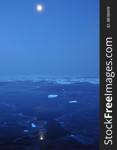 The moon hovers above the Arctic Ocean horizon Sept. 10, 2009. Photo Credit: Patrick Kelley, U.S. Coast Guard. The moon hovers above the Arctic Ocean horizon Sept. 10, 2009. Photo Credit: Patrick Kelley, U.S. Coast Guard