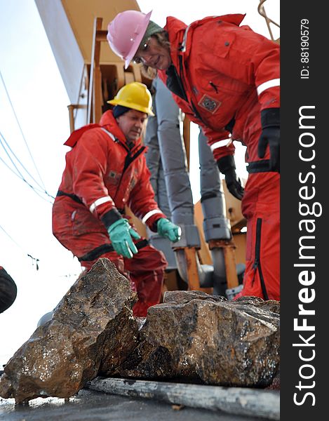 ARCTIC OCEAN - Dr. Alex Andronikov, a geologist from the University of Michigan Department of Geological Science, and Kelley Brumley, a geologist from Stanford University, sort through rocks that were dredged from the Arctic Ocean floor Sept. 9, 2009, aboard the Coast Guard Cutter Healy.The dredging is part of the U.S. Extended Continental Shelf Task Force&#x27;s effort to locate the outer reaches of the North American continental shelf.&#x28;U.S. Coast Guard photo by Petty Officer Patrick Kelley&#x29; Photo Credit: Patrick Kelley, U.S. Coast Guard. ARCTIC OCEAN - Dr. Alex Andronikov, a geologist from the University of Michigan Department of Geological Science, and Kelley Brumley, a geologist from Stanford University, sort through rocks that were dredged from the Arctic Ocean floor Sept. 9, 2009, aboard the Coast Guard Cutter Healy.The dredging is part of the U.S. Extended Continental Shelf Task Force&#x27;s effort to locate the outer reaches of the North American continental shelf.&#x28;U.S. Coast Guard photo by Petty Officer Patrick Kelley&#x29; Photo Credit: Patrick Kelley, U.S. Coast Guard