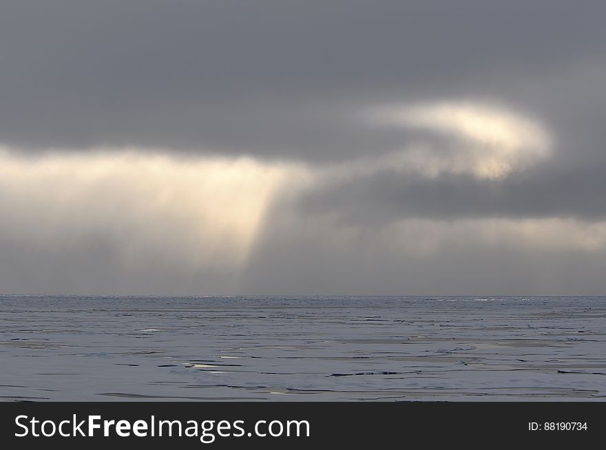 The sun shines through the clouds over the Arctic Ocean Aug. 17, 2009. Photo Credit: Patrick Kelley, U.S. Coast Guard. The sun shines through the clouds over the Arctic Ocean Aug. 17, 2009. Photo Credit: Patrick Kelley, U.S. Coast Guard