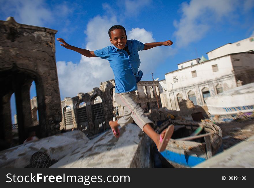 A Somali boy jumps between to old fishing boats above Mogadishu&#x27;s fishing harbour near the fish market in the Somali capital, 16 March, 2013. Every morning Mogadishu&#x27;s fisherman bring their catch ashore upon which it is quickly unloaded and transported to Xamar Weyne&#x27;s lively and chaotic fish market where it is sold for consumption on the local market and increasingly, for export to other countries. Over the last two decades, instability on land has greatly restricted the development of the country&#x27;s fishing industry, but now that Somalia is enjoying the longest period of sustained peace in over 20 years, there is large-scale potential and opportunity to harvest the bountiful waters off the Horn of Africa nation, which boasts the longest coastline in Africa. AU-UN IST PHOTO / STUART PRICE. A Somali boy jumps between to old fishing boats above Mogadishu&#x27;s fishing harbour near the fish market in the Somali capital, 16 March, 2013. Every morning Mogadishu&#x27;s fisherman bring their catch ashore upon which it is quickly unloaded and transported to Xamar Weyne&#x27;s lively and chaotic fish market where it is sold for consumption on the local market and increasingly, for export to other countries. Over the last two decades, instability on land has greatly restricted the development of the country&#x27;s fishing industry, but now that Somalia is enjoying the longest period of sustained peace in over 20 years, there is large-scale potential and opportunity to harvest the bountiful waters off the Horn of Africa nation, which boasts the longest coastline in Africa. AU-UN IST PHOTO / STUART PRICE.