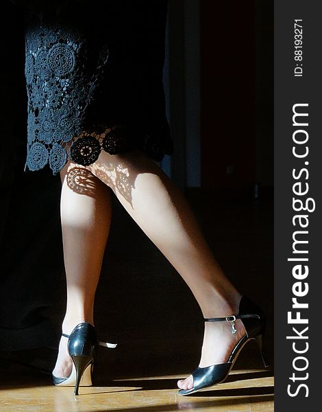 Legs of woman wearing black lace dress and high heels. Legs of woman wearing black lace dress and high heels.
