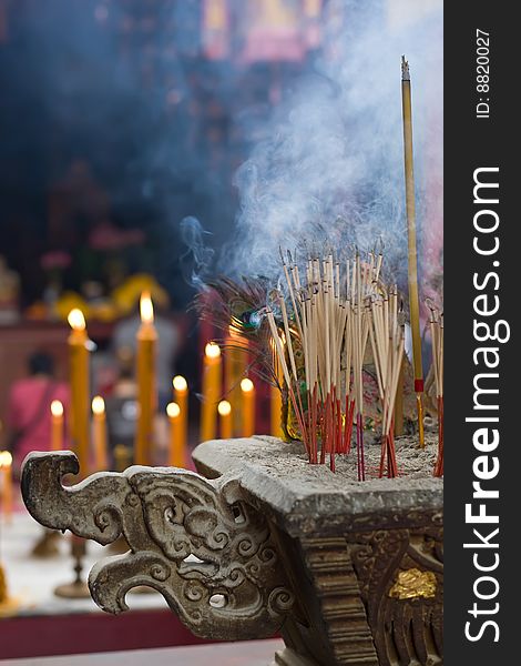 Joss sticks burn at an altar in temple