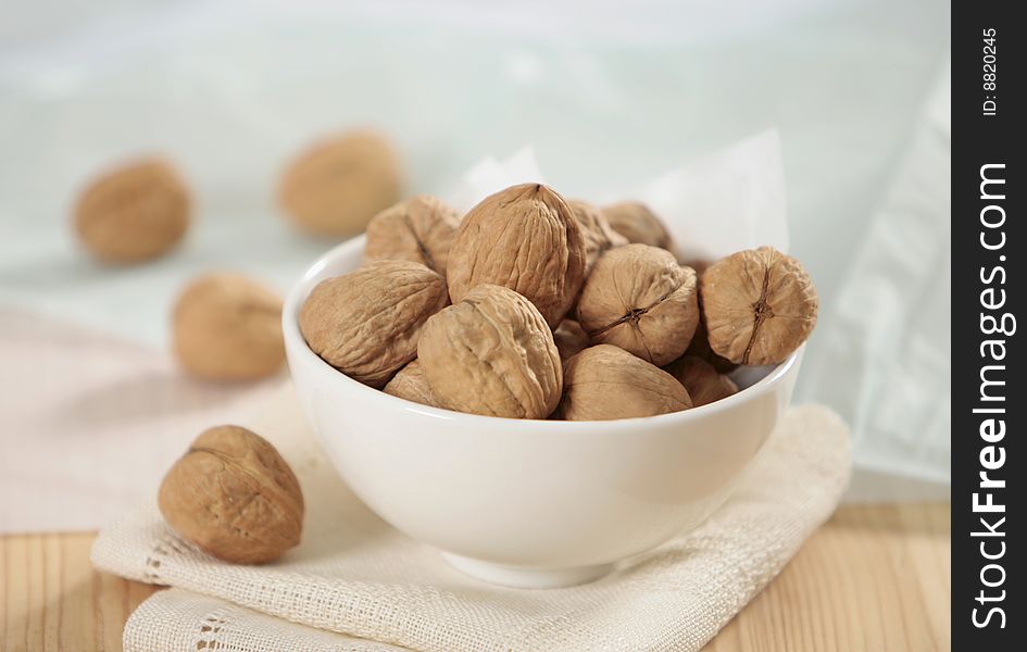 Closeup of walnuts in white bowl