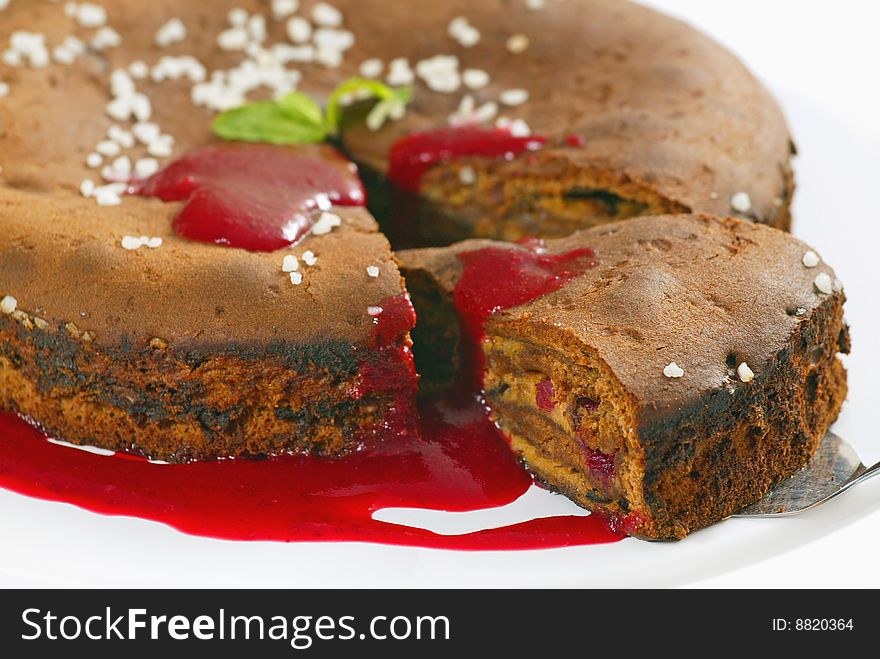 Brown cake with strawberry sauce. Brown cake with strawberry sauce
