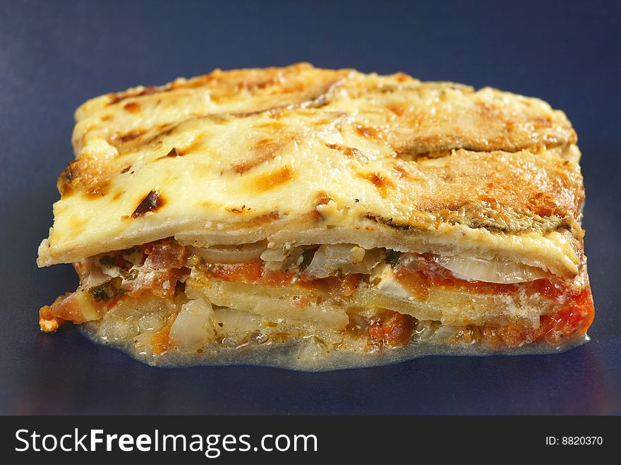 Fresh italian lasagna on blue background