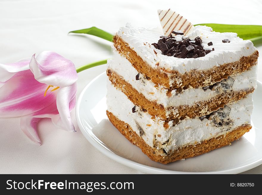 Cake and tulip on the white tablecloth