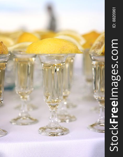 Tequila glasses with lemons on a table