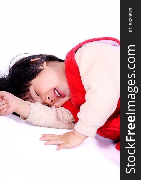 A picture of a little chinese girl laughing happily on the ground