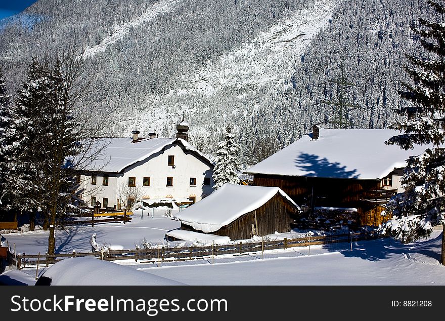 German homestead nestled at the bottom of the Alps