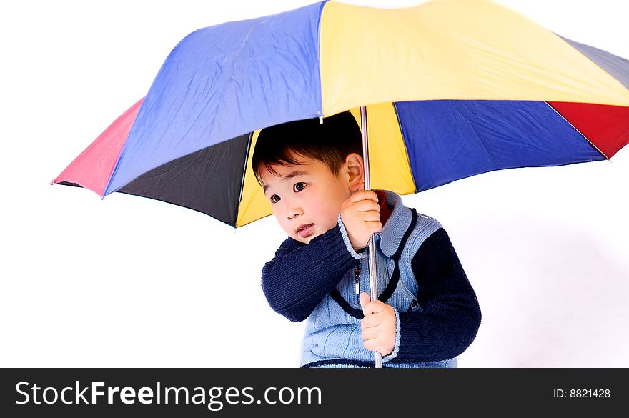 A picture of a little chinese boy holding a colorful umbrella. A picture of a little chinese boy holding a colorful umbrella