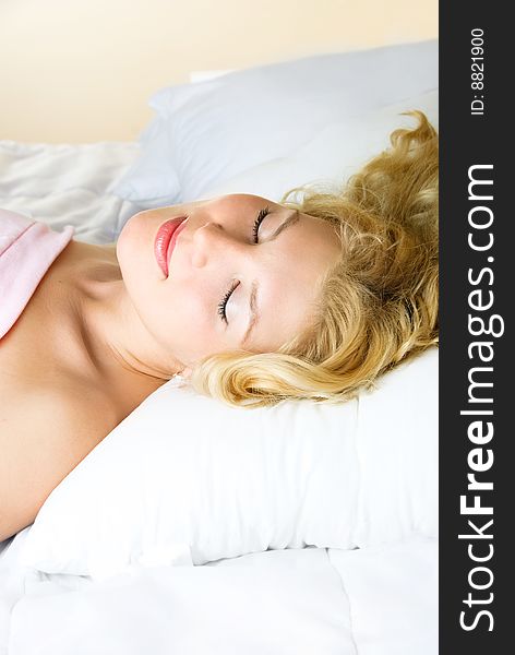 Beautiful young blond woman sleeping in her bed at home. Beautiful young blond woman sleeping in her bed at home