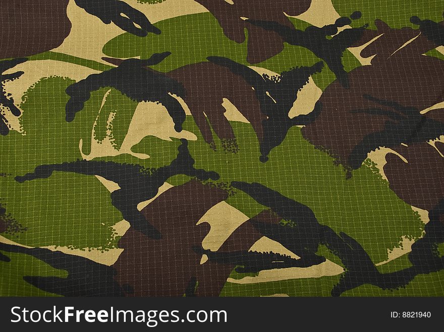 Combat camouflage cloth in green and beige background,check also Camouflage
