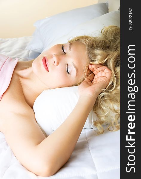 Beautiful young blond woman sleeping peacefully in her bed at home. Beautiful young blond woman sleeping peacefully in her bed at home