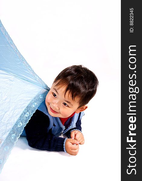 A picture of a little chinese boy hiding behind a light-colored umbrella. A picture of a little chinese boy hiding behind a light-colored umbrella