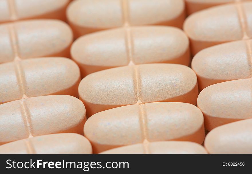 Closeup of orange pills on the table