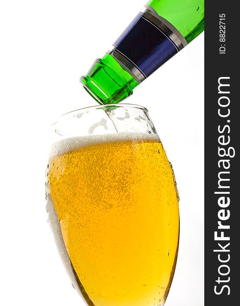 Image of a bottle of beer being poured into a glass. Image of a bottle of beer being poured into a glass