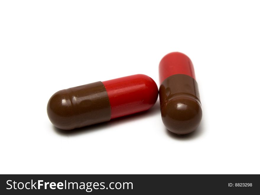 Brown - red pills on white background it is isolated