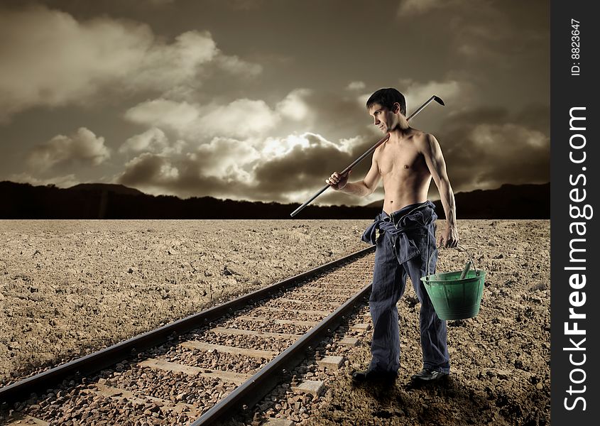 Worker with tools near the train tracks