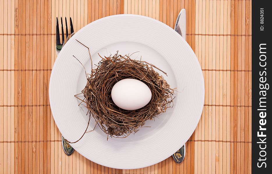 Egg in a nest served on a plate