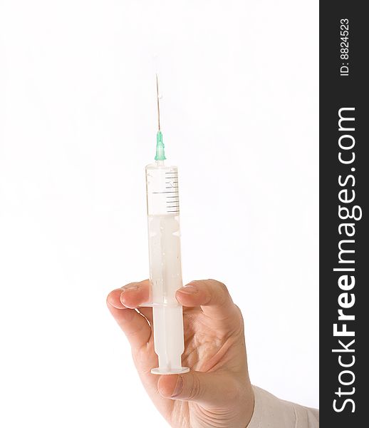 Medical syringe in front of a white background