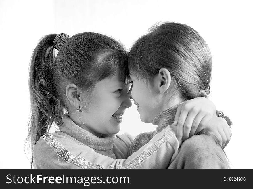 An image of two little girls looking at each other. An image of two little girls looking at each other