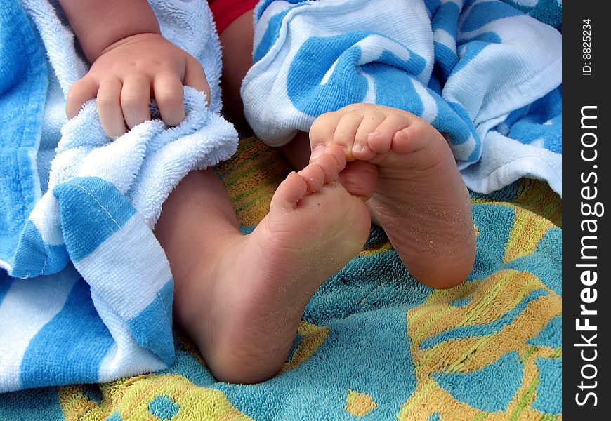 Close-up abstract photo of toddlers feet and hand. Close-up abstract photo of toddlers feet and hand