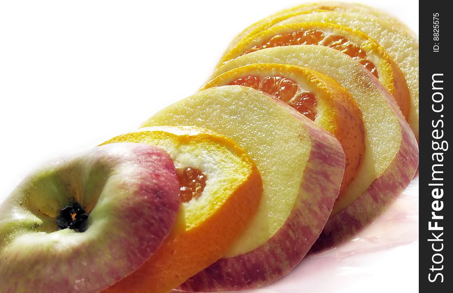 Fruit slicing of apples and oranges on a white background
