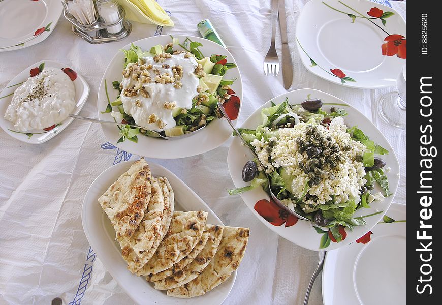 Tzatziki and greek salad in Fira, Santorini, Cyclades Islands, Greece. Tzatziki and greek salad in Fira, Santorini, Cyclades Islands, Greece