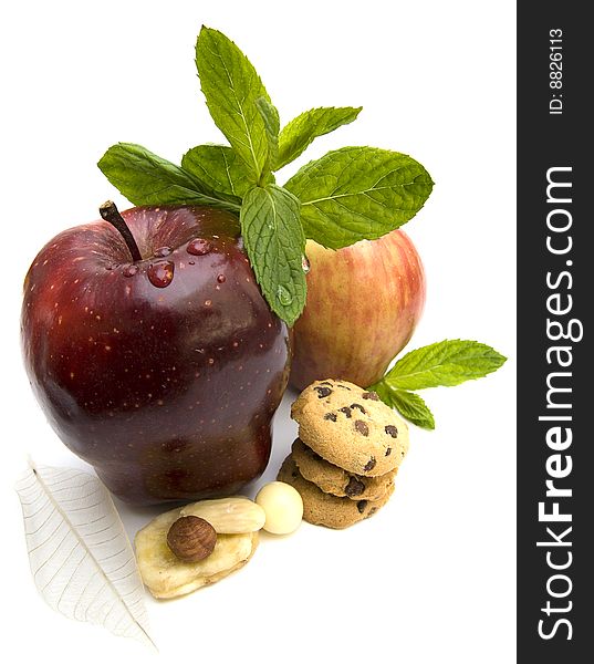 Two fresh ripe apples with mint, cookies and nuts. Two fresh ripe apples with mint, cookies and nuts