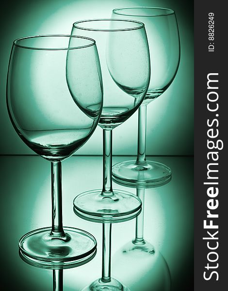 Wine glasses on a green background