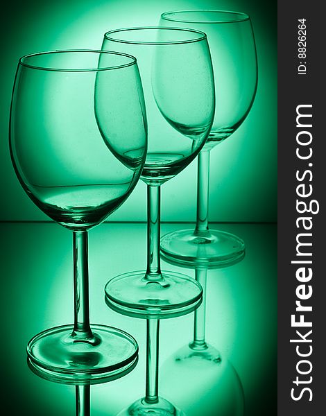 Wine glasses on a green background