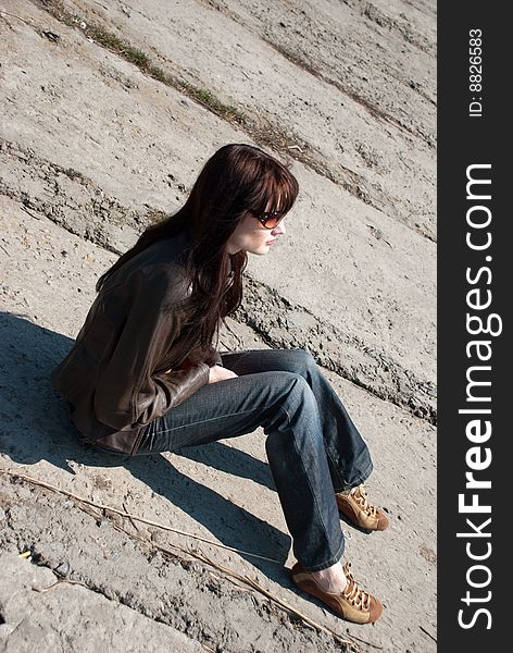 A girl with sun glasses on a stone background