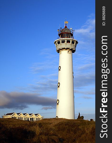 Dutch white lighthouse at the shore of the sea. Dutch white lighthouse at the shore of the sea