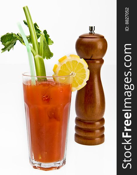 Bloody mary cocktail with a peppermill in the backround