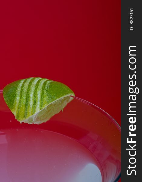 Close up of a Kamikazi cocktail over a red background