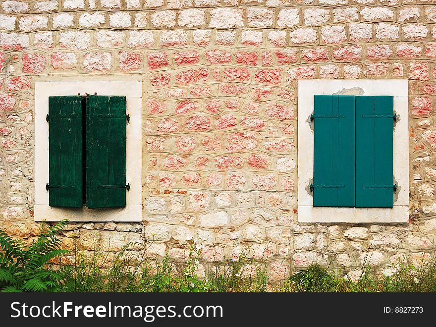 Windows of a Mediterranean house with wooden shutters. Windows of a Mediterranean house with wooden shutters