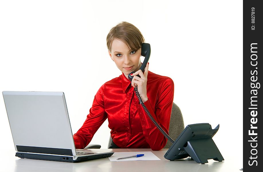 Receptionist at call center with laptop and desk phone