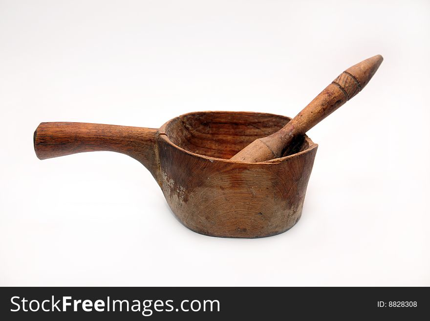 The ancient wooden kitchen utensils planed from an integral tree on a white background. The ancient wooden kitchen utensils planed from an integral tree on a white background