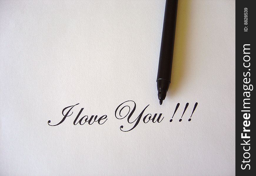 Close up view of the words I LOVE YOU written in classic type and black pen on a white paper. Close up view of the words I LOVE YOU written in classic type and black pen on a white paper