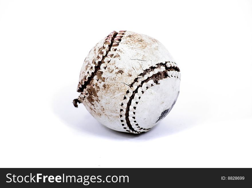 An old used baseball on a white background. An old used baseball on a white background.