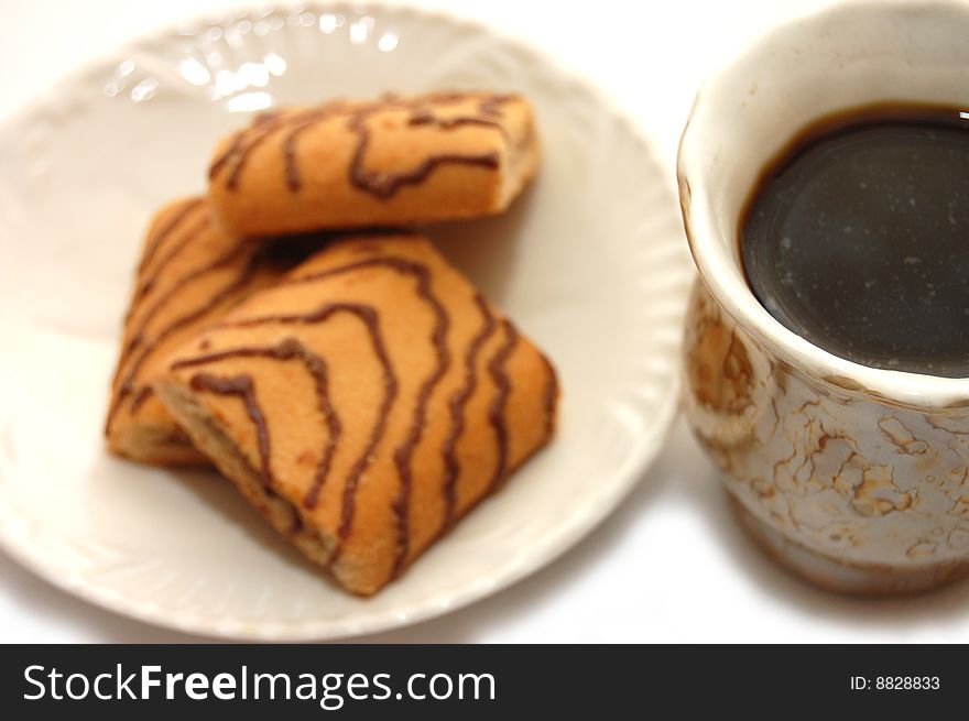 Kind with top on a cup about coffee and a plate with cookies. Kind with top on a cup about coffee and a plate with cookies