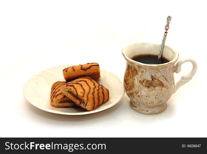The front view on a cup about coffee and a plate with cookies. The front view on a cup about coffee and a plate with cookies