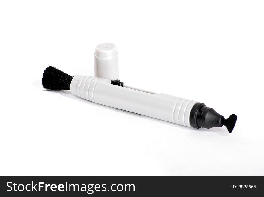 A camera cleaning brush on a white background. A camera cleaning brush on a white background.