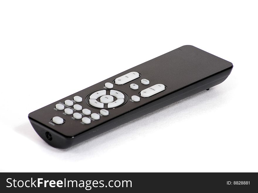 A black remote control on a white background. A black remote control on a white background.