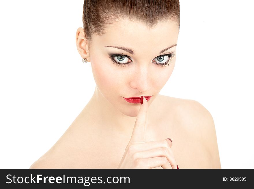 Portrait of the beautiful woman with a finger at the lips, isolated. Portrait of the beautiful woman with a finger at the lips, isolated