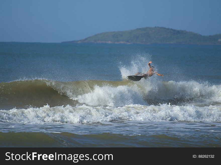 Surfer Surfing On Ocean Waves