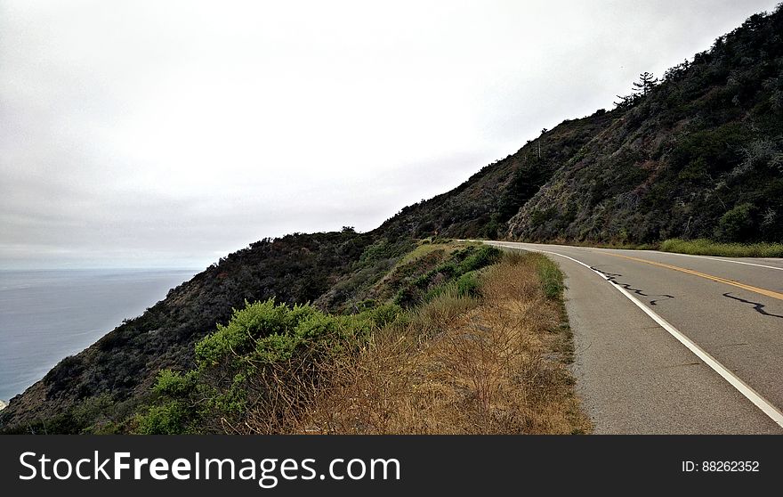 Road On Hillside By Ocean