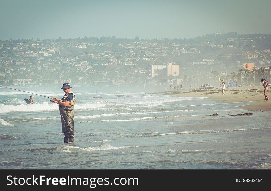 Man Fishing On Ocean Beach